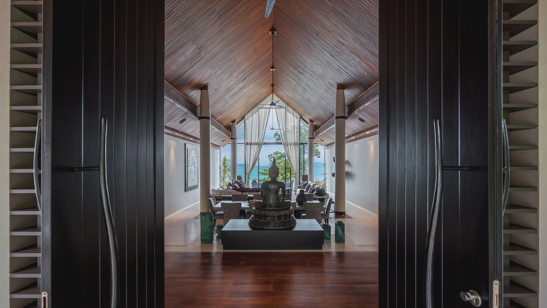 Vaulted living and dining hall with Thai art